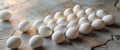 Fresh White Eggs Arranged Neatly on Textured Stone Surface with Soft Background Lighting. Royalty Free Stock Photo