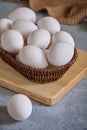 Fresh white eggs in a basket on a gray background Royalty Free Stock Photo