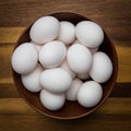 Fresh white eggs in a brown bowl on a wood countertop Royalty Free Stock Photo