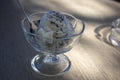 Fresh white light ice cream on wooden table, cup of glass with sundae, vanilla and chocolate, cold summer refreshing food Royalty Free Stock Photo