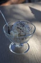 Fresh white light ice cream on wooden table, cup of glass with sundae, vanilla and chocolate, cold summer refreshing food Royalty Free Stock Photo