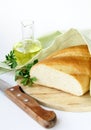 Fresh white loaf of bread with a knife , olive oil Royalty Free Stock Photo