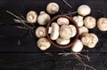 Fresh white mushrooms champignon on black wooden background. Top view. Copy space. Royalty Free Stock Photo