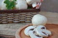 Fresh white mushrooms champignon in brown basket on wooden background. Top view. Copy space Royalty Free Stock Photo