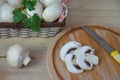 Fresh white mushrooms champignon in brown basket on wooden background. Top view. Copy space Royalty Free Stock Photo