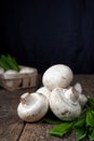 Fresh white mushrooms champignon in brown bowl on wooden background. Top view. Royalty Free Stock Photo