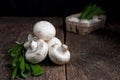 Fresh white mushrooms champignon in brown bowl on wooden background. Top view. Royalty Free Stock Photo