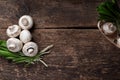 Fresh white mushrooms champignon in brown bowl on wooden background. Top view. Royalty Free Stock Photo