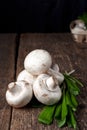Fresh white mushrooms champignon in brown bowl on wooden background. Top view. Royalty Free Stock Photo