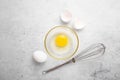 Fresh white organic broken chicken egg and shell, whisk on light background. Baking background. Royalty Free Stock Photo