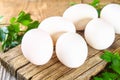 Fresh white raw chicken eggs with parsley on an old wooden table. Royalty Free Stock Photo