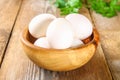Fresh white raw chicken eggs with parsley on an old wooden table. Royalty Free Stock Photo