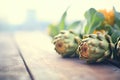 fresh whole artichokes on wooden surface Royalty Free Stock Photo