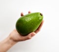 Fresh whole avocado in woman hand slices on white background