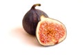 Fresh whole and bisected figs on white backdrop