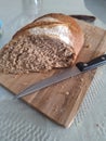 Fresh whole bread on chopping board Royalty Free Stock Photo