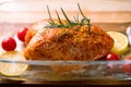 Fresh whole chicken with rosemary lemon and cherry tomatoes ready to be grilled Royalty Free Stock Photo