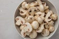 Fresh whole and chopped mushrooms in a round porcelain bowl Royalty Free Stock Photo