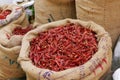Fresh whole dry red chilies stored in bag for sell in a market stall Royalty Free Stock Photo