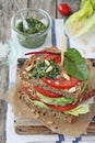 Fresh whole grain bread sandwich with green salad mix,tomato and pesto Royalty Free Stock Photo