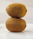 Fresh whole kiwis lie one on top