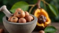 Fresh whole nutmeg on stone mortar with split nutmeg fruit and tree in background Royalty Free Stock Photo