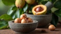 Fresh whole nutmeg on stone mortar with split nutmeg fruit and tree in background Royalty Free Stock Photo