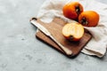 Fresh whole persimmon on wooden background Royalty Free Stock Photo