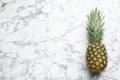Fresh whole pineapple on white marble background, top view Royalty Free Stock Photo
