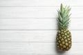 Fresh whole pineapple on white wooden background, top view Royalty Free Stock Photo