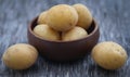 Fresh whole potatoes wooden bowl