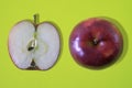 Fresh Whole red apple fruit and half isolated on yellow background Royalty Free Stock Photo