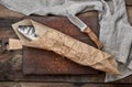 Fresh whole sea bass fish wrapped in a brown paper