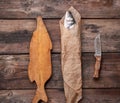 Fresh whole sea bass fish wrapped in a brown paper  and tied with a rope Royalty Free Stock Photo