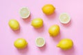 Fresh whole and sliced lemon on pink background. Flat lay. Royalty Free Stock Photo