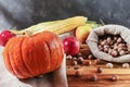 Fresh whole vegetables: pumpkin, apples, corn and nut hazelnuts in a bag. Autumn harvest