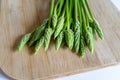 Fresh wild asparagus on a wooden background ready to be cooked Royalty Free Stock Photo