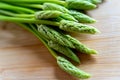 Fresh wild asparagus on a wooden background ready to be cooked Royalty Free Stock Photo