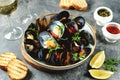 Fresh wild mussels in shells with green onions, garlic, parsley, chili pepper, white wine and olive oil. Royalty Free Stock Photo