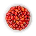 Fresh wild rose hips, also rose haws or rose heps, in white bowl Royalty Free Stock Photo