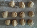 Fresh yeast dough for pizza or bread, cut into small pieces and rolled into the balls. Dough rolled into balls. Homemade dough.