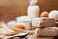 Fresh yeast and ingredients for baking on wooden kitchen table. Product for preparing pizza or bread.