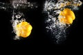 Fresh Yellow Bell Pepper with Water Splash and Bubble Isolated. Copy Space. Juicy Yellow Paprika Dropped into Water on Black Royalty Free Stock Photo
