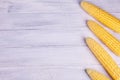 Fresh yellow corn on the cob kernels on a white wooden background. Royalty Free Stock Photo