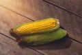Fresh yellow corn with cobs on rustic wooden table