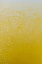 Fresh yellow fruits juice background texture with foam. Orange water bubbles. Macro. Royalty Free Stock Photo