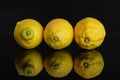 Fresh yellow lemon isolated on black glass Royalty Free Stock Photo