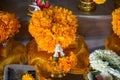 Fresh yellow Marigold floral garland arrangement with Crown flower and jasmine on golden color offering tray with pedestal