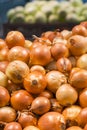 Fresh yellow onions as a background. Vegetable store. Yellow onion lies in a box in a store for sale. vertical photo Royalty Free Stock Photo