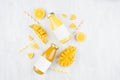 Fresh yellow orange juice and mango juice in glass bottles with blank label, ingredients on white wood board, mock up for design. Royalty Free Stock Photo